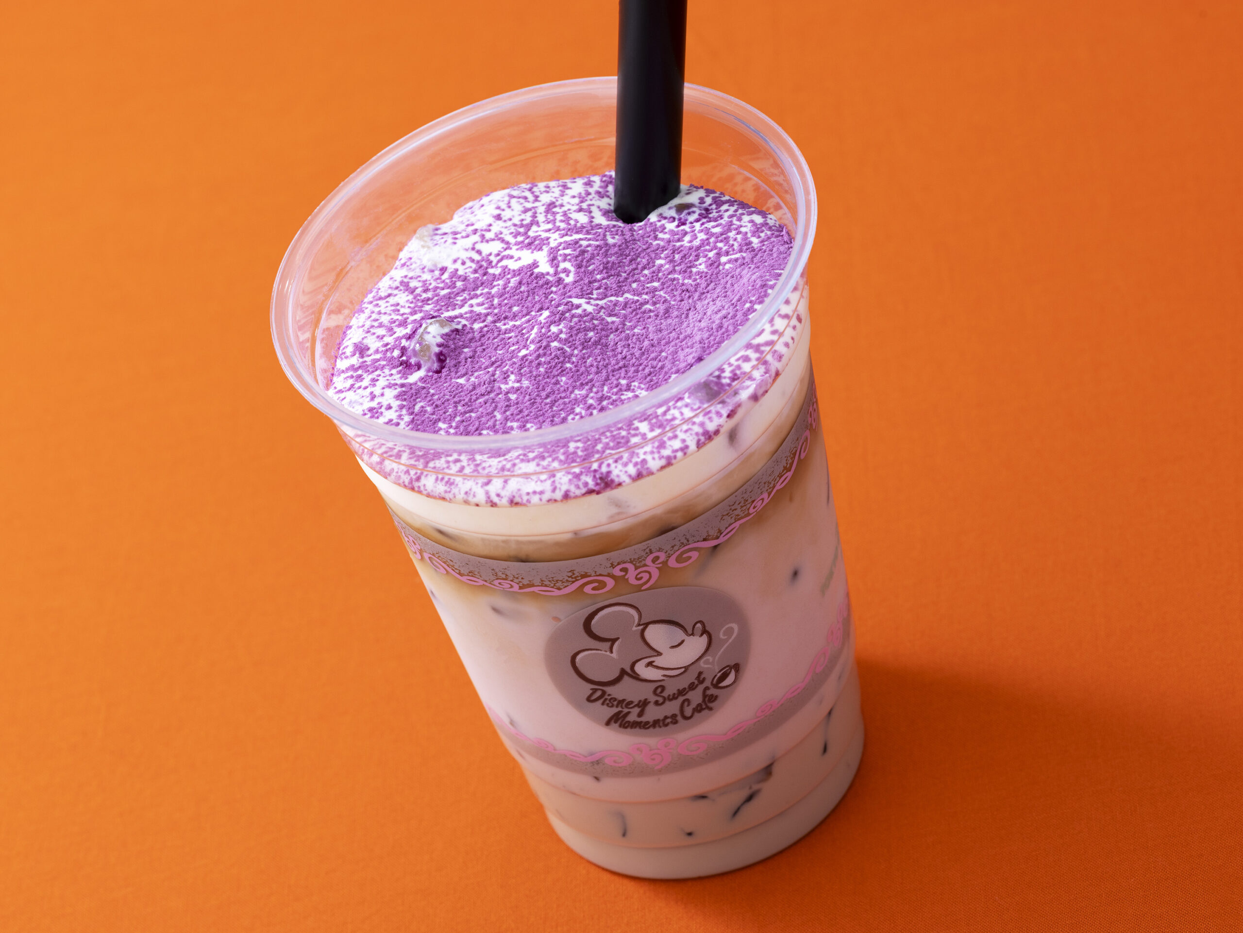 Disney Sweet Moments Cafeのカップに入った紫色のパウダーがかかったアイスカフェラテ